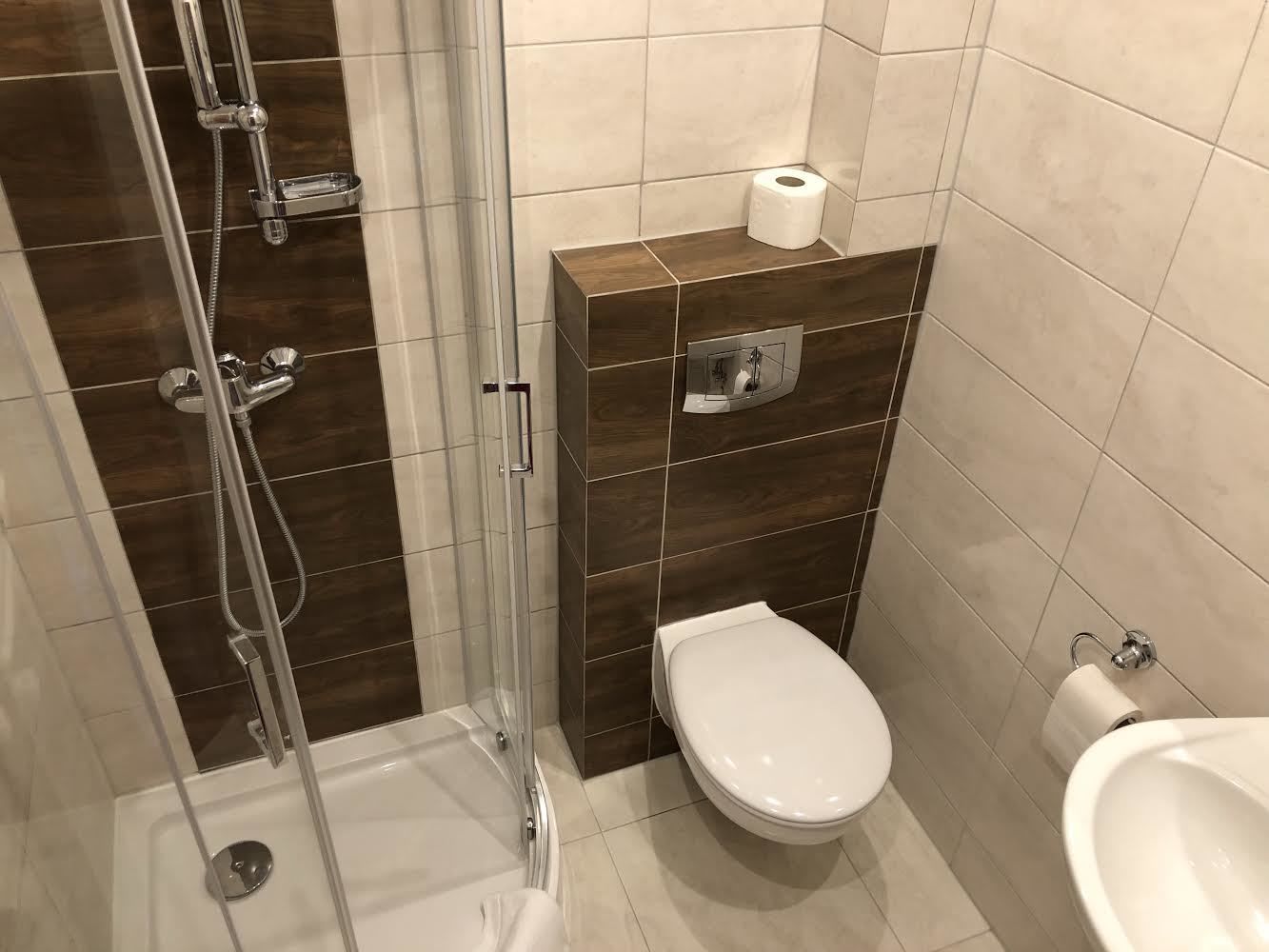 Et moderne badeværelse med bruseniche, toilet og bidet.