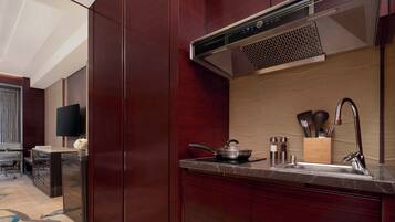 A modern kitchen with a built-in stove, a sink, and a range hood.