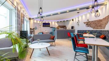 A modern interior with a dining area, kitchen, and seating space.