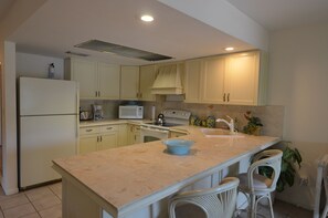 Duplex, 2 Bedrooms, Bay View, Garden Area | Private kitchen | Full-size fridge, microwave, oven, stovetop - Oasis at John's Pass Madeira Beach (Madeira Beach)