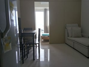 Condo, 1 Bedroom, Balcony, City View | Living area | Flat-screen TV - Wind Residences by SMCo (Tagaytay)