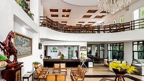 A spacious lobby with a high ceiling, a chandelier, and a seating area with wooden chairs. - Wangyao Riverside Resort (Nakhon Nayok)