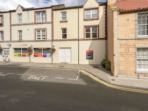 A building with a 'cash' sign, a 'Nisa local' shop, and a 'ONLY' road marking. - Fidra (North Berwick)