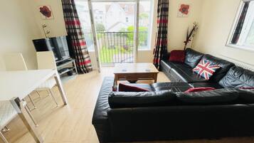 Apartment, Multiple Beds | Living area | TV