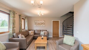 A living room with a sofa set, a coffee table, and a chandelier. - Lord Galloway 32 (H 2016) 82334 (Newton Stewart)