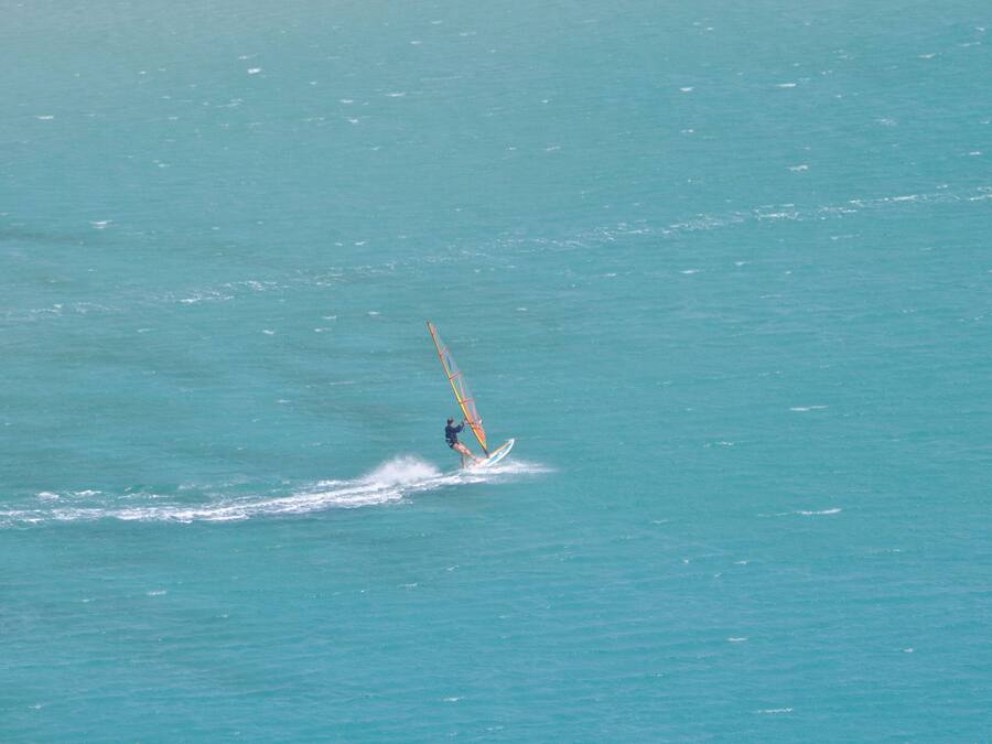 A person windsurfing in a large body of water.