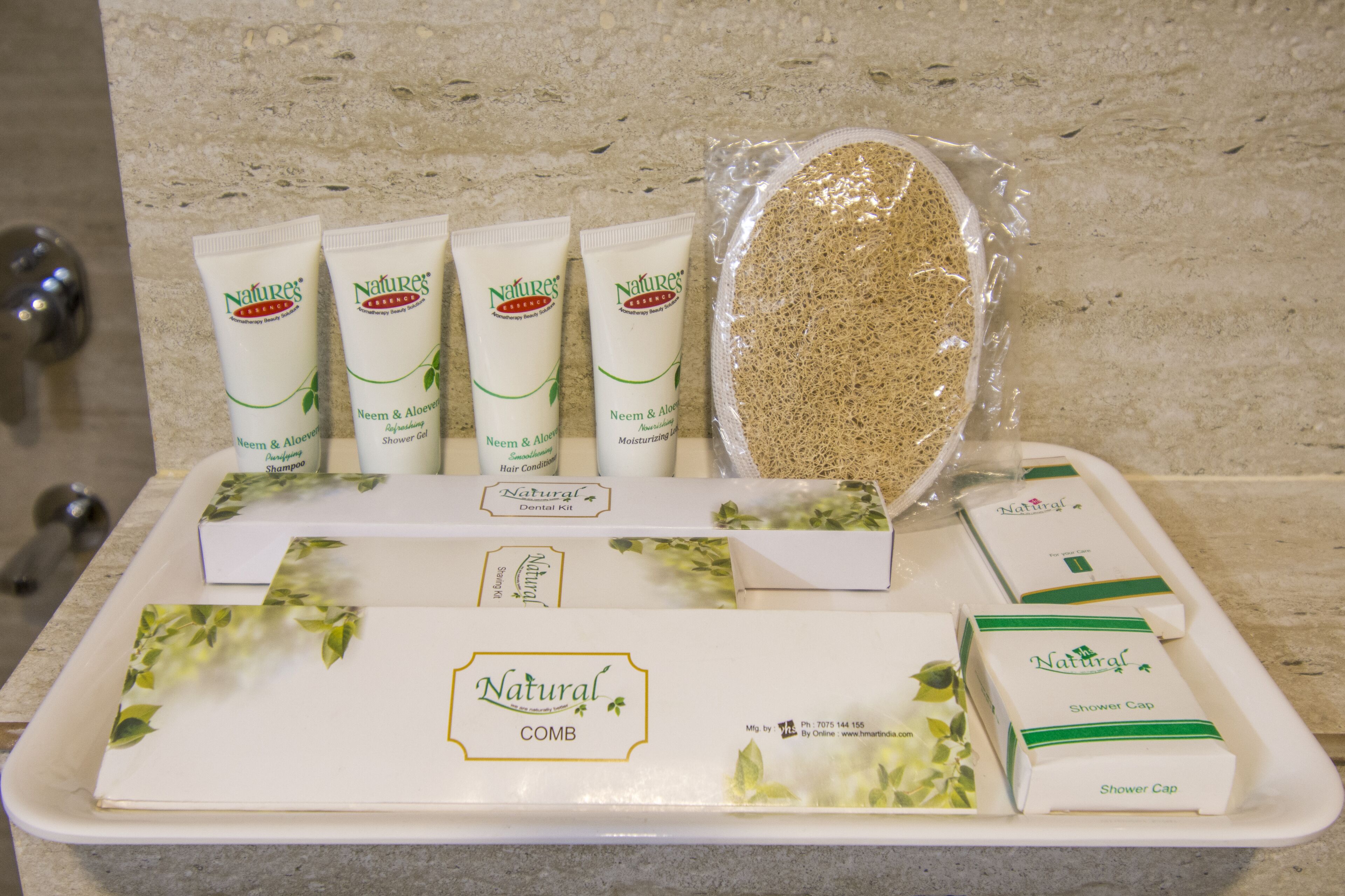 A tray with various natural personal care products including shampoo, conditioner, and a dental kit.