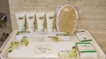 A tray with various natural personal care products including shampoo, conditioner, and a dental kit.