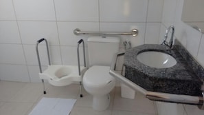 A bathroom with a standard toilet, a bidet, and a granite sink. - Hotel Casas Novas (Penapolis)
