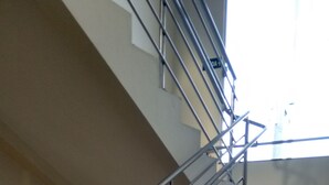A staircase with metal railings and beige steps.
