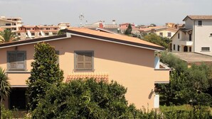 A residential building with a flat roof, multiple windows, and a satellite dish. - M & I Apartment (Fiumicino)