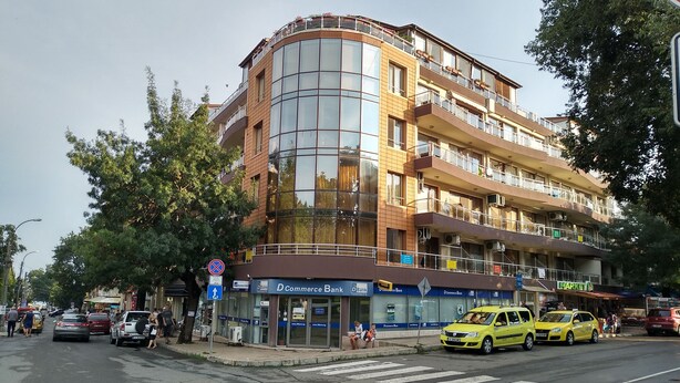 A multi-story building with a D Commerce Bank on the ground floor. - Sunny Sands Studios (Burgas)
