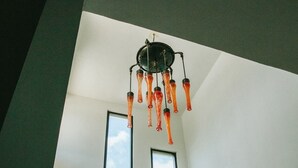 A staircase with a modern design, leading to a room with large windows and a unique ceiling light fixture. - Enjoy space and privacy Casa Roo by BRM (Tulum)