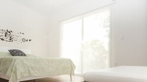 A modern bedroom with a bed, a bench, and a large window. - Prana 212 by BRM (Tulum)
