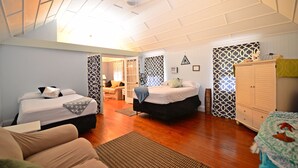 A spacious room with two beds, a sofa, and a wardrobe. - Historic Apartment in the Center of Christiansted (Christiansted)