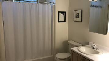 Shower, hair dryer, towels, toilet paper