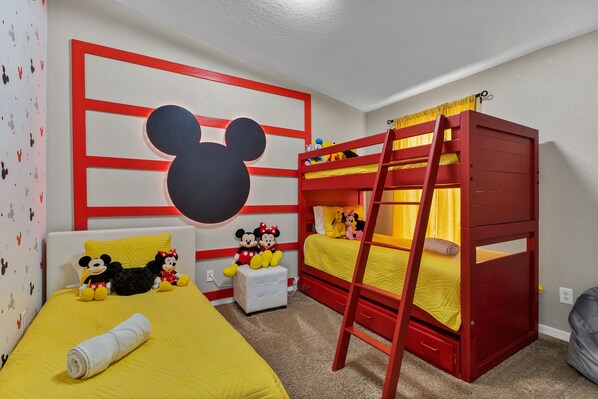 A child's room with a bunk bed, a Mickey Mouse wall decoration, and a ladder. - Luxury House close to Disney in Golf Resort 31848561 (Davenport)