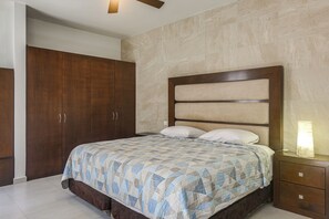 A bedroom with a bed, nightstand, and wardrobe. - 1 Mi to Beach: Luxe Playa Del Carmen Home w/ Pool (Playa Del Carmen)