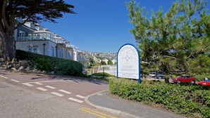 A sign for Compass Point Luxury Apartments with a compass rose, indicating a private residential area with no unauthorized access.