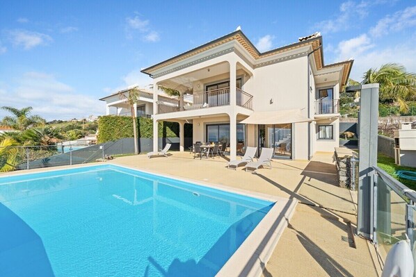 A heated pool, pool loungers