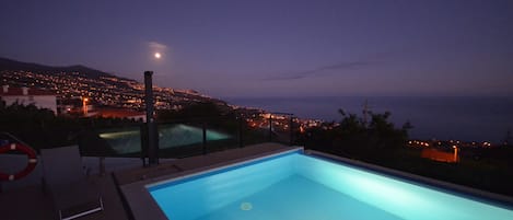 Outdoor pool, an infinity pool, pool loungers