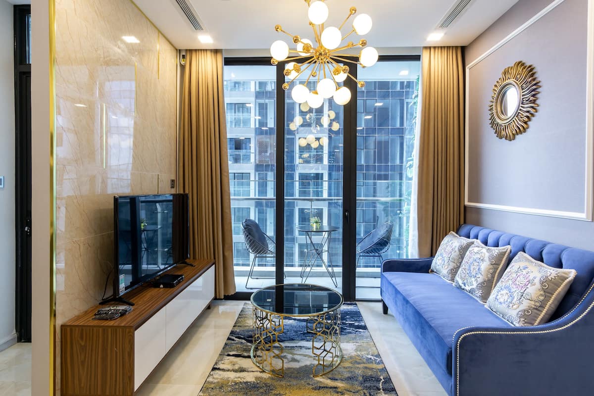 Deluxe Apartment, 2 Bedrooms | Living room | 50-inch flat-screen TV with cable channels, TV