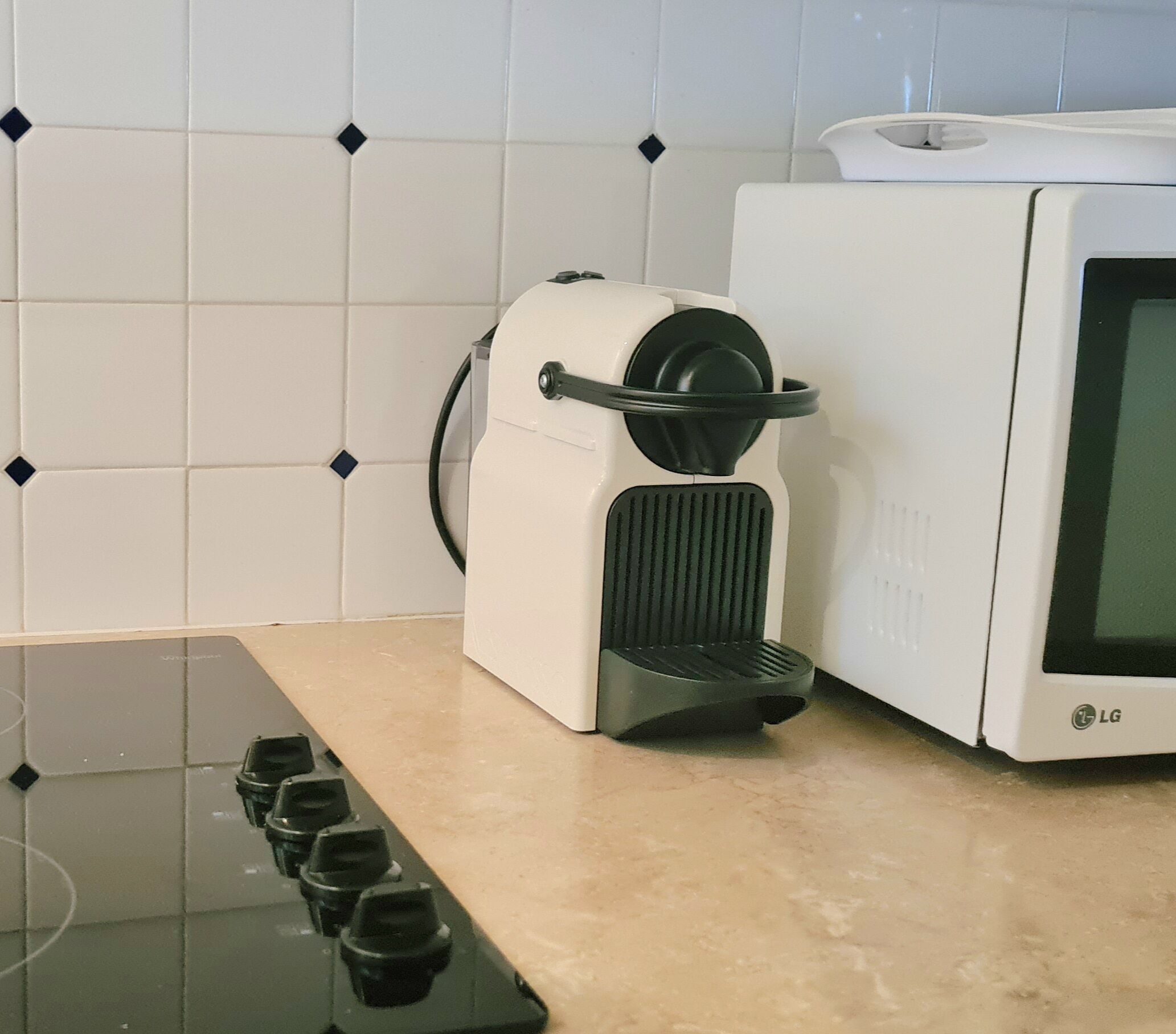 A kitchen with a stove, a microwave, and a coffee maker.