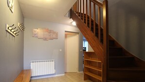 A staircase with wooden railings leading to a second floor. - Family-friendly with pets allowed and WiFi (Cérences)