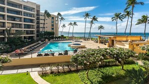 A hotel with a pool, palm trees, and a view of the ocean. - DIRECT Oceanfront! Amazing Panoramic View Sugar Beach 236! Refresh, Relax, Enjoy (Kihei)