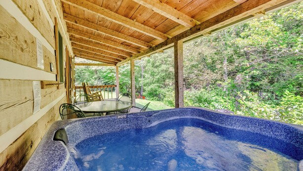 A wooden cabin with a hot tub, a dining table, and chairs outside. - Creekside Bliss! Back Yard Creekside Retreat !!! (Cosby)
