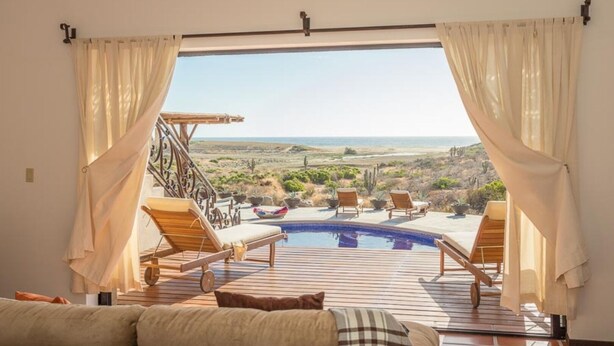 A room with a view of a pool and outdoor seating. - Fabulous Fall and Winter:  HEATED POOL! (Todos Santos)