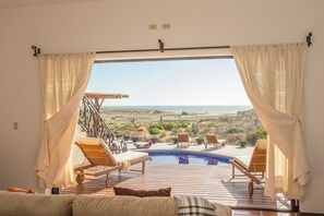 A room with a view of a pool and outdoor seating. - Fabulous Fall and Winter:  HEATED POOL! (Todos Santos)