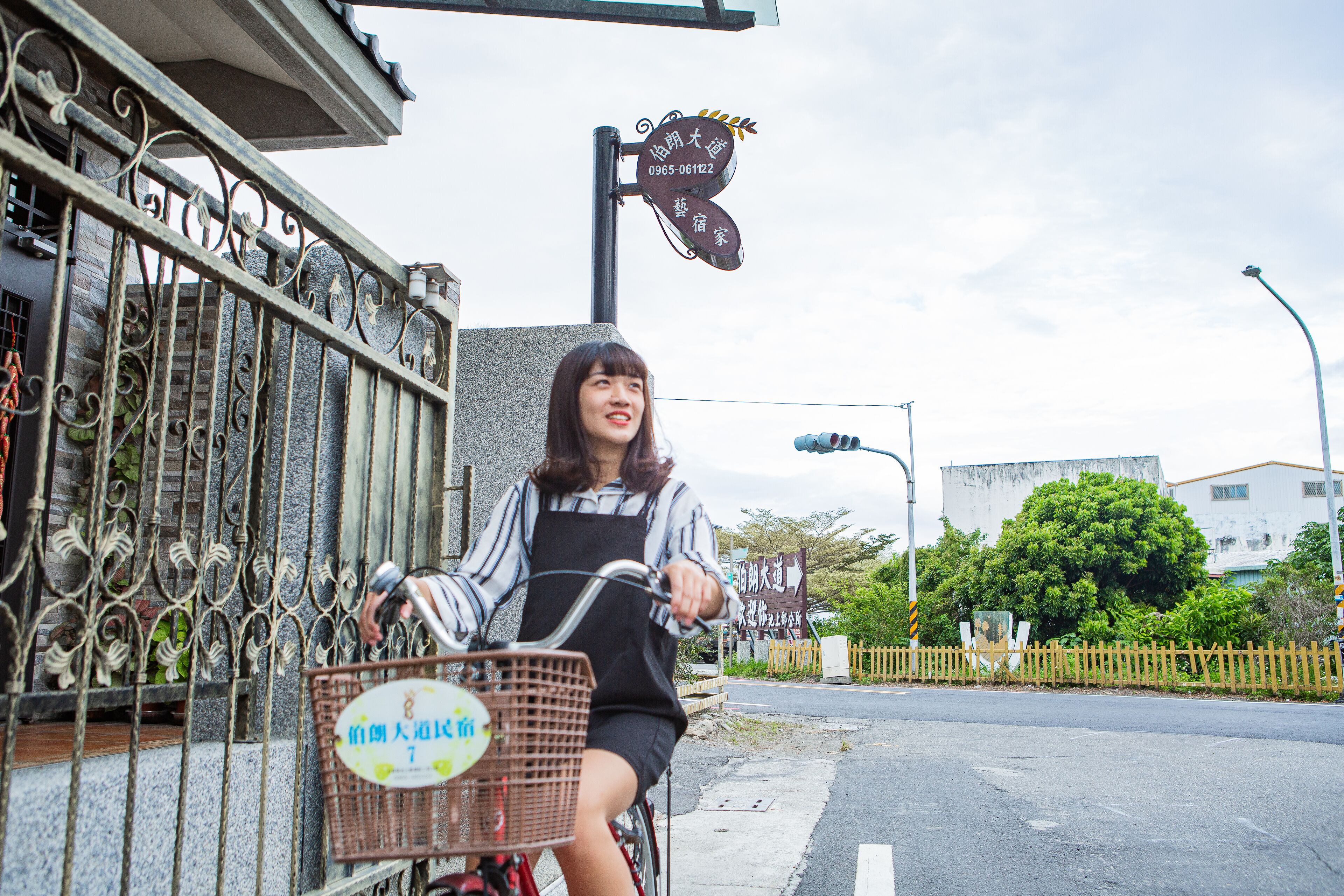 A person riding a bicycle with a basket in front.