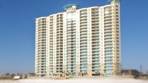 A high-rise hotel with multiple balconies, located near a beach. - Stunning 11th Floor Gulf-View Retreat at Aqua Resort Free Beach Chairs (Panama City Beach)