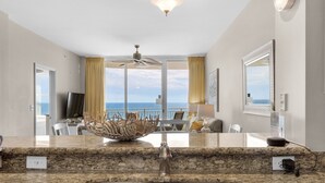 A modern kitchen with a granite countertop, stainless steel sink, and a decorative bowl centerpiece. - Stunning 11th Floor Gulf-View Retreat at Aqua Resort Free Beach Chairs (Panama City Beach)