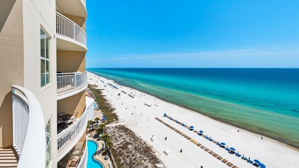 A beachfront hotel with a pool, beach chairs, and umbrellas. - Stunning 11th Floor Gulf-View Retreat at Aqua Resort Free Beach Chairs (Panama City Beach)