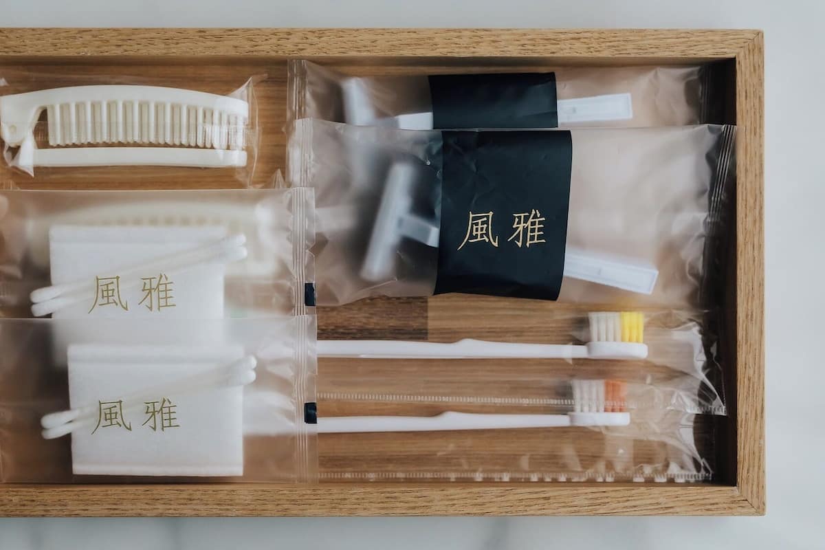 A wooden box containing various toiletries and personal care items.