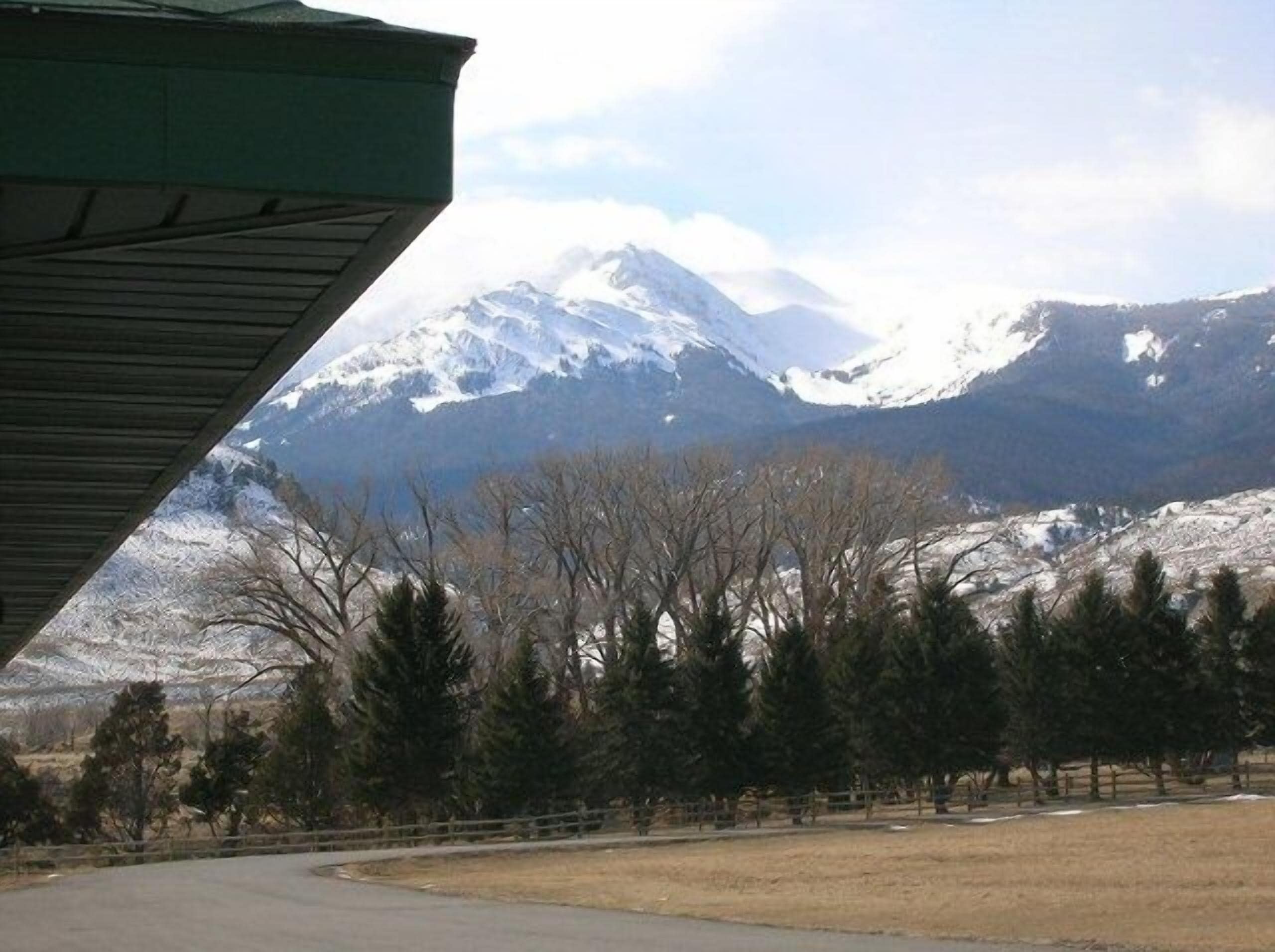 A mountain landscape with snow-capped peaks and a clear sky.