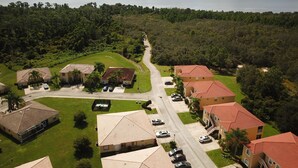 A residential area with houses, a road, and a lake in the background. - Gem of Lake Marion! Beautiful 3 Bedroom with King Beds, HD & Internet (Kissimmee)