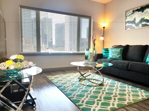 A living room with a sofa, coffee table, and decorative items.