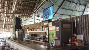A bar area with stools, a counter, and a television screen. - Travellers Inn Resort Malindi (Malindi)