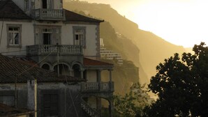 A building with a balcony and a staircase leading up to a higher level. - Charming OLD TOWN Penthouse W Large Private Sea Balcony  (Funchal)