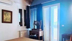 A bedroom with a wooden ceiling, a bed, a desk, a chair, and a window with curtains. - Villa Gloria Maria, Swimming Pool - CIN:IT087024C2QQKFD6UP (Mascalucia)