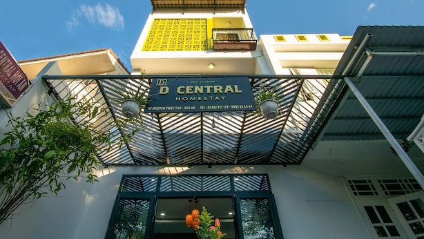 A building with a sign reading "D CENTRAL HOMESTAY" and contact information. - D Central Homestay Hoi An (Da Nang)