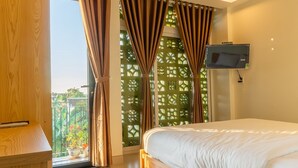 A modern bedroom with a large bed, wooden ceiling, and a view of greenery outside. - D Central Homestay Hoi An (Da Nang)