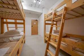 A room with bunk beds, a wooden ladder, and a door. - HOSTEL COCONE Kyoto - Station (Kyoto)