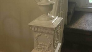 A staircase with white balusters and a white urn on a pedestal. - Geomara 2 Bdroom Ppl Center (Nairobi)