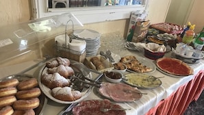 A buffet table with various food items including pastries, meats, and condiments. - Cinquestelle-albergo del centro storico (Centola)