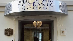 The exterior of Hotel Don Carlo restaurant with a sign above the entrance, a balcony, and a flag. - Hotel Don Carlo 4S (San Marco Argentano)