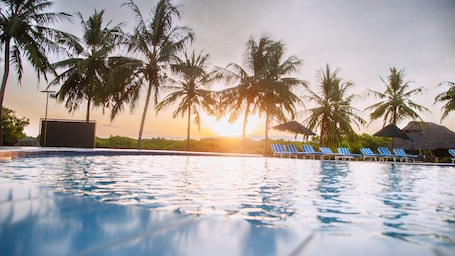 Outdoor pool, sun loungers. Tanga Beach Resort & Spa